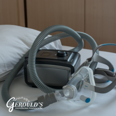 CPAP machine and mask on a bed next to a pillow